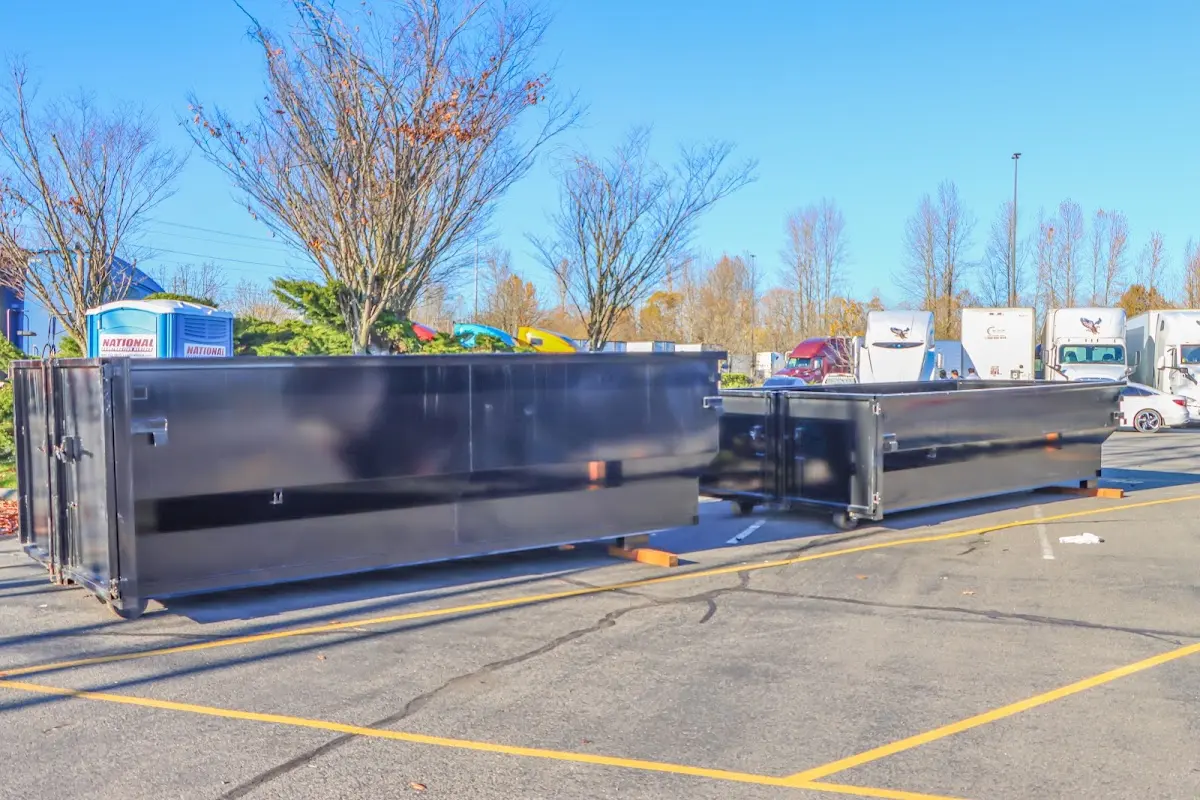 Professional dumpster rental service with roll-off container on residential driveway in Pontoon Beach